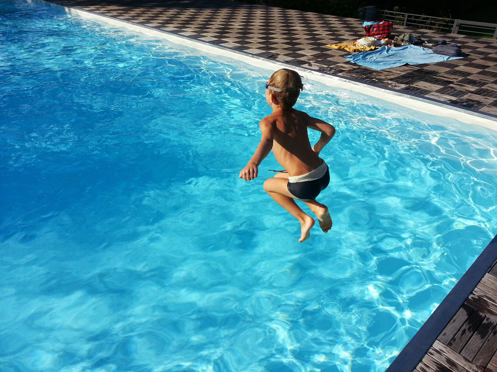 Child Jumping Into Pool